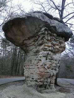 a large rock sitting on the side of a road