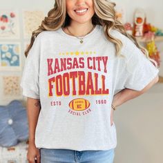 a woman wearing a kansas city football t - shirt