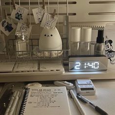 an alarm clock sitting on top of a kitchen counter next to utensils and other items