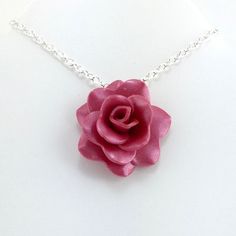 This rose necklace is handmade from pomegranate red (light) polymer clay. Each petal is hand formed to make a beautiful rose, no molds are used. The rose measures 1-1/4 inches across (about 3.5cm) and has a silver plated bail. This rose pendant is Made to Order so you will not receive the exact rose pendant that is pictured but it will be extremely similar. The color will be exactly the same but the petals may lay slightly differently. Includes your choice of silver plated necklace. Your rose wi Jewelry Polymer Clay, Photo Locket Necklace, Heart Photo, White Jewelry Box, Red Pomegranate, Simple Rose, Photo Necklace, Jasper Necklace, Rose Pendant