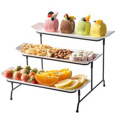 three tiered serving trays filled with fruit and pastries