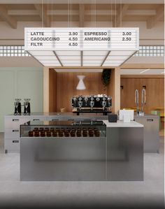 a large sign is hanging from the ceiling above a counter with donuts on it