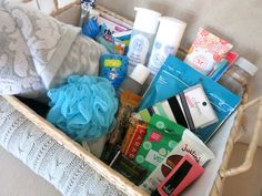 a basket filled with personal care items on top of a couch next to a pillow