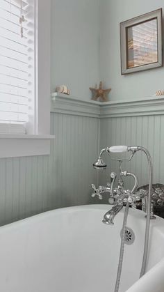 a white bath tub sitting next to a window