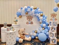 a teddy bear themed birthday party with balloons and decorations on the floor, including a baby's 1st birthday cake