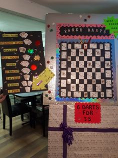 two large pieces of paper with writing on them are displayed in front of a table