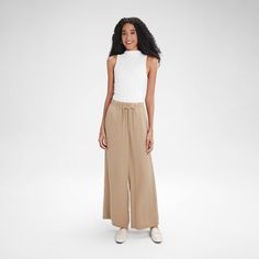 Add a touch of sophistication to your look with our wide-leg pull-on pants. The contrasting wide elastic waistband and narrow drawstring create an elegant, refined style. Made from midweight textured twill fabric, they offer a casual feel with a touch of structure, making them ideal for early autumn. Featuring a wide-leg fit and convenient side pockets, these pants are versatile enough to pair with a variety of tops for any occasion. A New Day™: Style that goes wherever you do. Spring Beige Wide Leg Pants With Pull-on Style, Chic Pull-on Style Wide Leg Pants For Loungewear, Chic Wide Leg Loungewear Pants With Pull-on Style, Chic Wide Leg Pants With Elastic Waistband For Daywear, Elegant Wide Leg Lounge Pants With Pull-on Style, Chic Pull-on Pants For Daywear, Chic Beige Pull-on Style Pants, Wide Leg Pull-on Pants For Day Out, Chic Wide Leg Pull-on Pants For Day Out