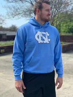 UNC Game Day Hoodie by Champion – Shrunken Head Athleisure Hoodie For Fan Gear, Fan Gear Long Sleeve Hoodie With Adjustable Hood, Fan Apparel Long Sleeve Sweatshirt With Adjustable Hood, Blue Hooded Hoodie For Sports Season, Blue Hooded Hoodie For Sports Events, Blue Long Sleeve Hoodie For Team Spirit, Blue Team Spirit Hoodie For Streetwear, Blue Sports Team Themed Hoodie, Blue Fleece Hoodie With Team Spirit