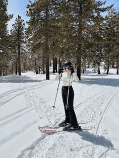 a woman on skis standing in the snow