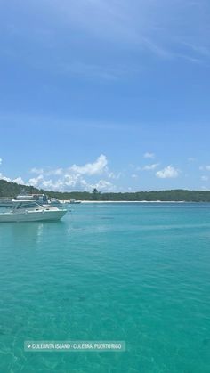 several boats are anchored in the clear blue water