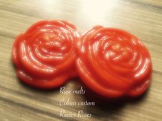 three red tomatoes sitting on top of a wooden table with the words rose meats