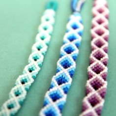 three different colored beads on a green surface