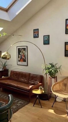 a living room filled with furniture and pictures on the wall