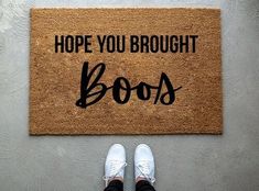 someone standing in front of a door mat that says, hope you brought books