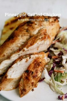 a white plate topped with chicken and coleslaw