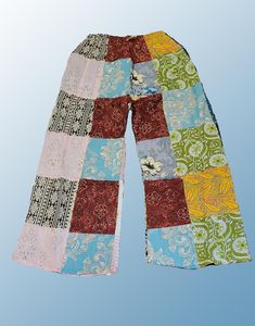 Introducing our Wevez Patchwork Pants, perfect for any casual occasion. These pants come in a beautiful pink and blue pattern and are made of high-quality cotton fabric with a drawstring closure and elastic waist for a relaxed fit. The wide-leg style and patchwork accents give these pants a unique hippie boho vibe, making them a great addition to any wardrobe. These one-size-fits-all pants are suitable for women of all sizes and are perfect for yoga, urban outings, or just lounging at home. The palazzo style adds to the comfortability of the pants while the cotton material provides breathability and durability. Get your hands on these stylish pants from the trusted brand Wevez today! Patchwork Pants, Palazzo Style, Boho Yoga, Festival Pants, Stylish Pants, Hippie Festival, Boho Vibe, Blue Pattern, Cotton Material