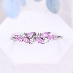 an image of a ring with pink stones on it