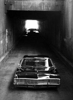 an old car is parked in a tunnel