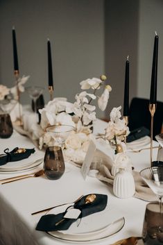 the table is set with black and white place settings