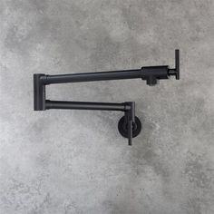 two black handles on a gray wall