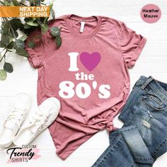 "I Love the 80s Tshirt, Womens 80s Clothing, 80's Shirt, 80's Gifts, 80s Party Shirt, 80's Baby Shirt, Retro Shirt Women, 80s Lover Gifts ----- How To Order ----- 1-) Please, check and review all the photos. 2-) Choose your t-shirt size and color. *Different styles of shirts may have different shades of same color choice due to different manufacturer brands. *For this reason, we recommend you to match shirts from the same styles if you want precisely matching colors (ex. Unisex, V-necks, Toddler 90s Style Summer Birthday Tops, 90s Summer Tops For Birthday, 80 Shirts 80s Style, 90s Summer Birthday Tops, 90s Inspired Graphic Print Tops For Birthday, 90s Inspired Letter Print Top For Birthday, 80 Themed Shirt, 90s Inspired Summer Birthday T-shirt, 80s Band Shirts