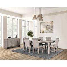 a dining room table with chairs and a rug in front of the window is shown