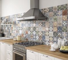 a stove top oven sitting inside of a kitchen next to a wall covered in tiles