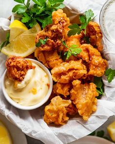 fried chicken with ranch dressing and lemon wedges