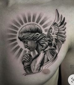 a man's chest with an angel tattoo on it