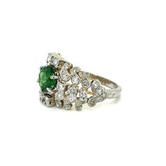 This Edwardian Ring is a timeless and elegant piece. Crafted circa the 1900s, it boasts a 1.64 ct Tsavorite Garnet with .80 ct diamonds, set in a beautiful platinum over 18-karat yellow gold design. Wear it to add a classic and luxurious flair to any outfit. Edwardian Ring 1.64ct Tsavorite Garnet .80ct Diamonds Platinum over 18KY Antique (Circa 1900s) at Regard Jewelry in Austin, Texas Luxury Tsavorite Diamond Ring, Edwardian Ring, Tsavorite Garnet, Gold Design, Austin Texas, Garnet, Austin, Platinum, Texas