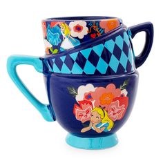 two blue cups are stacked on top of each other, one is decorated with cartoon characters