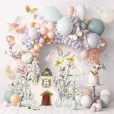 an image of a cake surrounded by balloons and other decorations on the wall in front of it