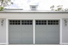 two garage doors on the side of a house