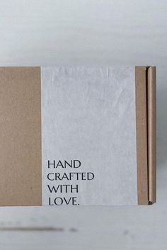 a brown box with some type of paper on top of it that says hand crafted with love