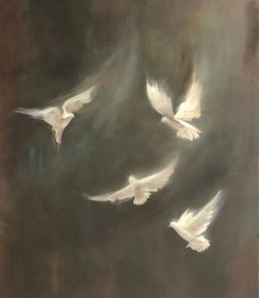 three white birds are flying in the sky