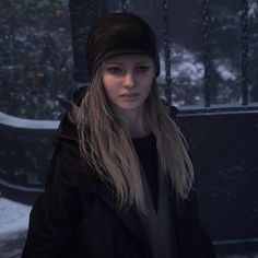 a woman with long blonde hair wearing a black coat and hat in the snow,