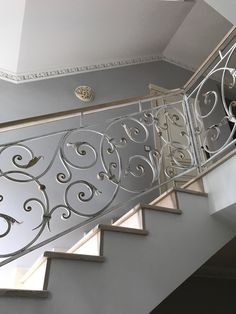 an iron stair railing with decorative designs on it