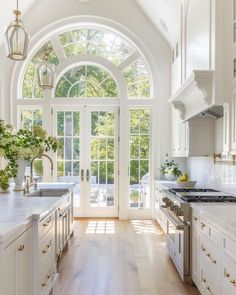 a kitchen with an arched ceiling and white cabinets