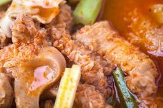 a close up view of some food in a bowl with broth and other vegetables