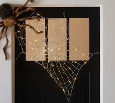 a door decorated with spider webs and lights