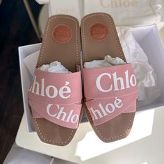 Pre-Loved Chloe Woody Slides. Retails $475 New. Mine Have Been Worn A Handful Of Times, Condition Is Excellent. Color Code Is Delicate Pink. They Discontinued This Color, It’s A Light Pink And Super Cute For Feminine And Pink Lover. Size 36. Fits True To Size. Bought At Nordstrom (See Last Pic For Proof Of Purchase Sticker). I Will Remove That Sticker At Time Of Shipping For Privacy Purposes. Will Ship With Original Box, 2 Dust Bags And A Booklet Chic Pink Flat Slides, Chic Slides With Branded Insole And Flat Heel, Chic Pink Round Toe Slides, Designer Spring Slip-on Sandals, Flat Logo, Chloe Shoes, Color Code, Ribbon Slides, Slide Sandals