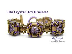 the bracelet is made up of gold and purple beads with an amethorate center