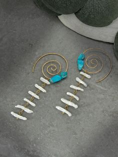 Capture a piece sacred geometry in these hand-shaped & hammered spiral threader hoop earrings. Adorned with natural freshwater baroque biwa stick pearls & genuine Sleeping Beauty Turquoise from Arizona, these one of a kind intentional earrings reflect the symbolism found throughout life's journey. Embrace the essence of the Desert & the Sea with peace of mind knowing these earrings are crafted in the USA with ethically sourced gemstones that tell a unique story. Hammered Spiral Threader Hoop Earrings With Biwa Pearl Dangles & Sleeping Beauty Turquoise (Earrings Only): ✿ Raw USA bronze, raw USA brass, natural baroque freshwater biwa stick pearls, genuine Sleeping Beauty turquoise from Arizona Please note - Items are made with raw bronze, copper & brass which may obtain a natural patina (dar Bohemian Spiral Hand Wrapped Jewelry, Unique Spiral Jewelry For Festivals, Bohemian Spiral Jewelry For The Beach, Bohemian Spiral Jewelry For Festivals, Copper Plating, Biwa Pearls, Sacred Stones, Bohemian Aesthetic, Ocean Jewelry