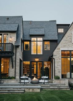 a large house with lots of windows and steps leading up to the front door area