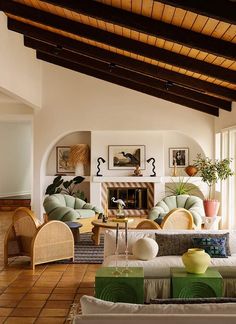 a living room filled with furniture and a fire place in the middle of a room