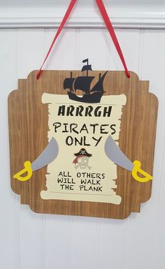 a wooden sign hanging from the side of a door that says ahrrah pirates only all others will have their planks