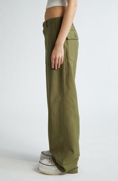 These utility pants are cut in a wide-leg silhouette from Japanese surplus military sateen that's slubbed and treated with an enzyme wash for softness. 32 1/2" inseam; 22" leg opening; 13 1/2" front rise; 17" back rise (size 29) Button fly Front slant pockets; back button-flap patch pockets 100% cotton Machine wash, dry flat Imported SPACE: A shop for emerging and advanced designers Military Wide Leg Cotton Cargo Jeans, Spring Military Wide Leg Cargo Pants, Spring Military Style Wide Leg Cargo Pants, Spring Military Wide-leg Cargo Pants, Military Style Wide Leg Khaki Bottoms, Military Style Khaki Wide Leg Bottoms, Utility Wide Leg Pants With Welt Pockets, Khaki Wide Leg Cargo Pants With Welt Pockets, Military Wide-leg Bottoms With Patch Pockets