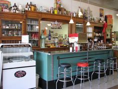 an old fashioned bar with stools at the counter