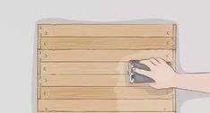 a person using a paint roller on a wooden planked board with nails and glue