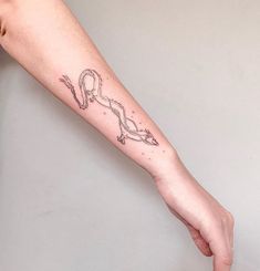 a person's arm with a tattoo on it and an arrow in the middle